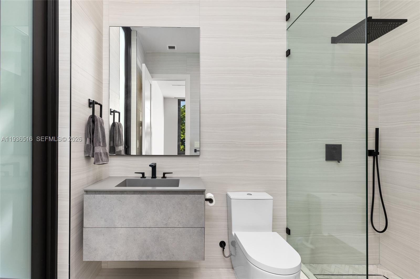 6003 Southwest 80th Street South Miami, FL 33143 - Photo 38 of 98 a bathroom with a granite countertop sink mirror and toilet