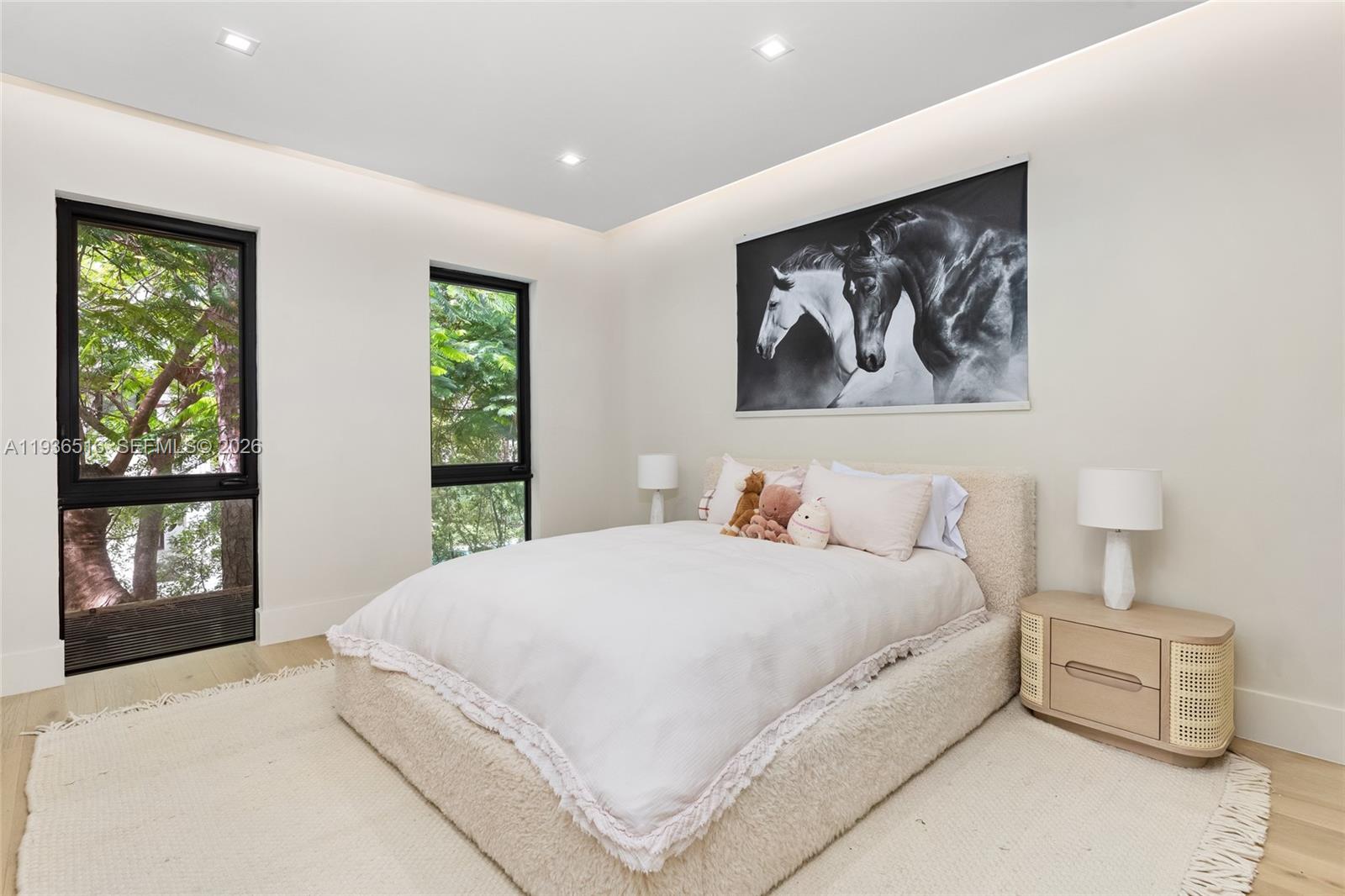 6003 Southwest 80th Street South Miami, FL 33143 - Photo 54 of 98 a bedroom with a large bed and a large window