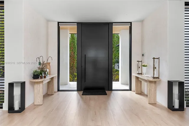 a living room with furniture kitchen view and a large window