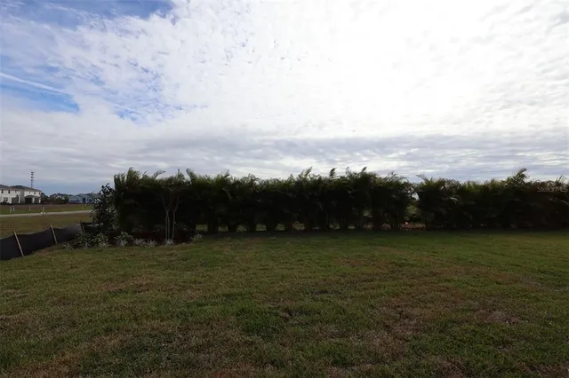 a aerial view of a house with swimming pool and outdoor seating