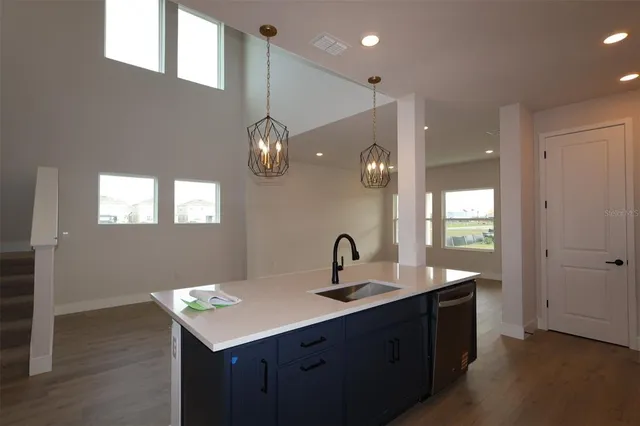 a kitchen with a sink stainless steel appliances and cabinets