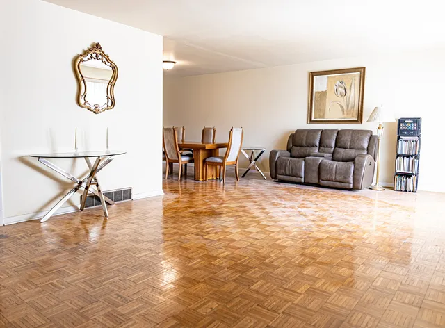 a living room with furniture and a dining table