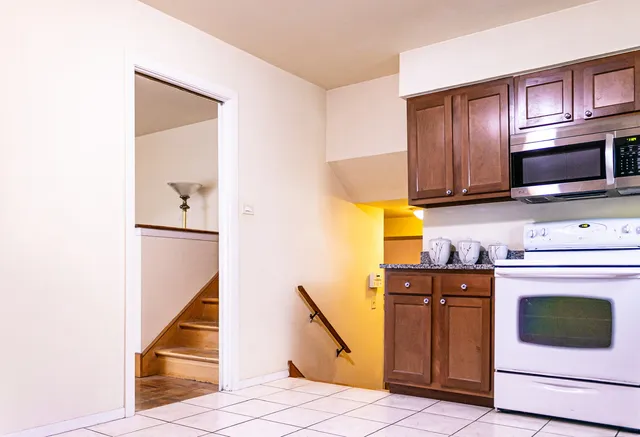 a kitchen with stainless steel appliances granite countertop a stove and a microwave
