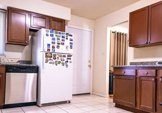 a kitchen with stainless steel appliances granite countertop a refrigerator and a stove