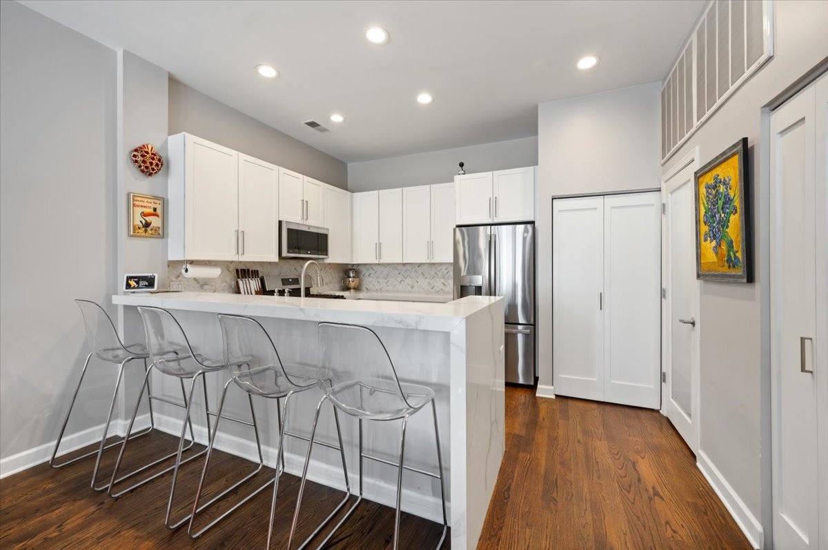 930 North Howe Street Chicago, IL 60610 - Photo 9 of 27 a kitchen with stainless steel appliances a refrigerator and a stove top oven