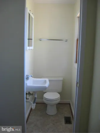 a white toilet sitting next to a small bathroom
