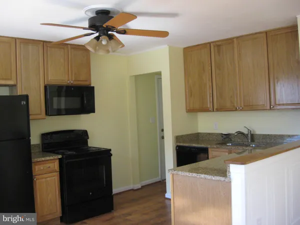a kitchen with a sink a stove and a microwave