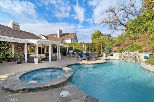 a view of a patio with swimming pool table and chairs