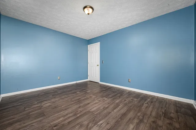 a view of an empty room and wooden floor