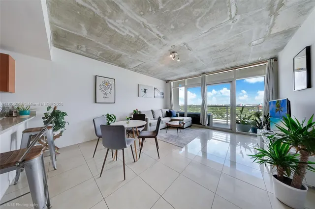 a living room with furniture potted plant and a window