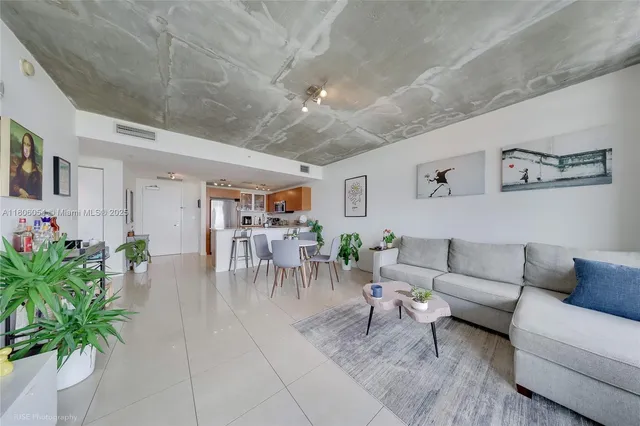 a living room with furniture and flowers