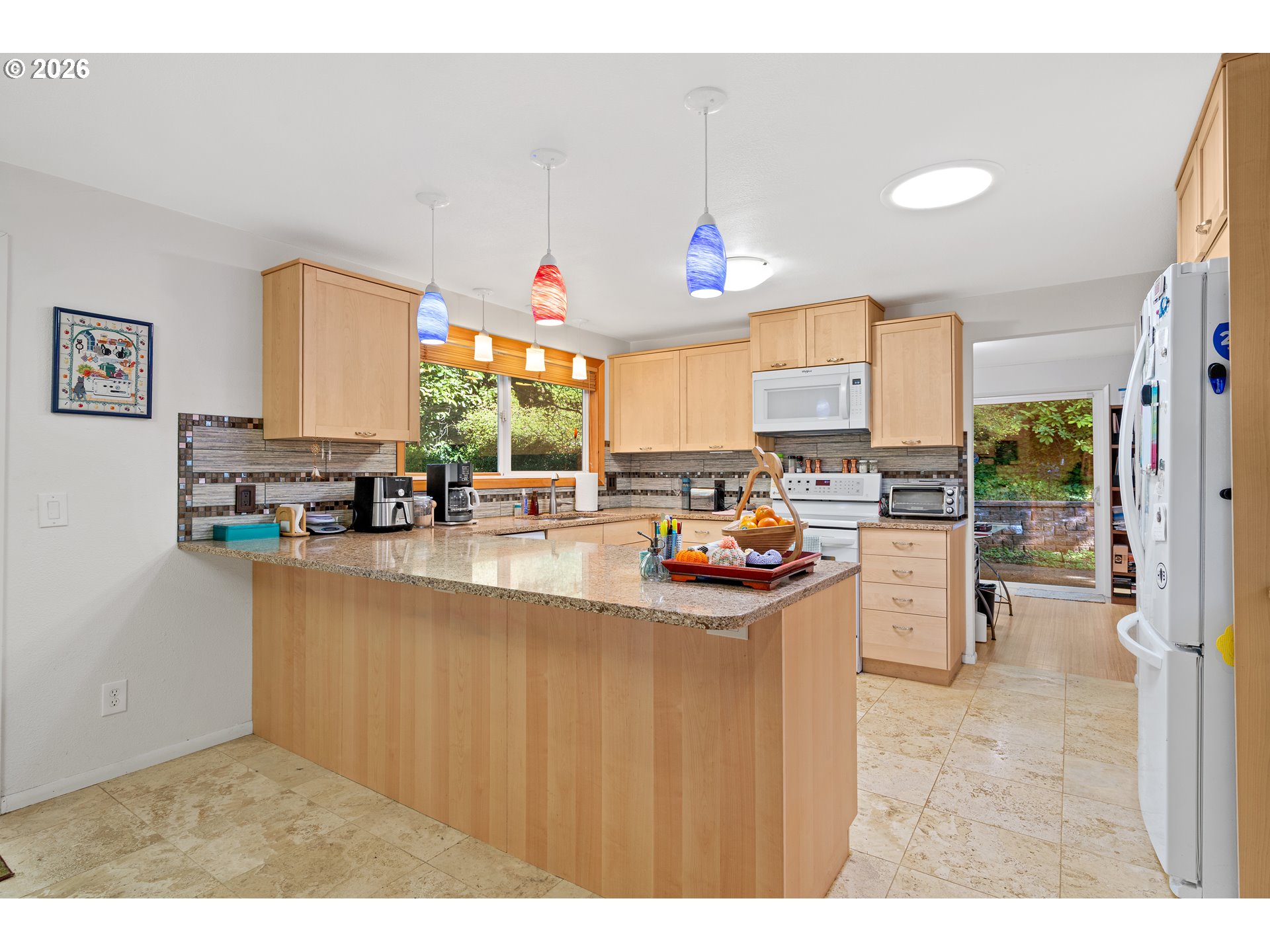 214 Northwest Seblar Drive Portland, OR 97210 - Photo 8 of 36 a open kitchen with stainless steel appliances granite countertop a sink stove and refrigerator