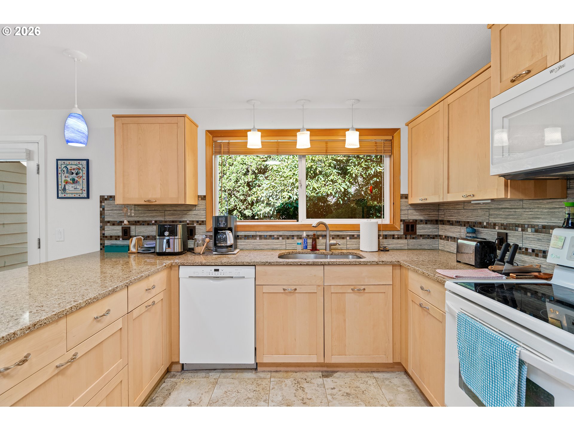214 Northwest Seblar Drive Portland, OR 97210 - Photo 10 of 36 a kitchen with a sink cabinets and window