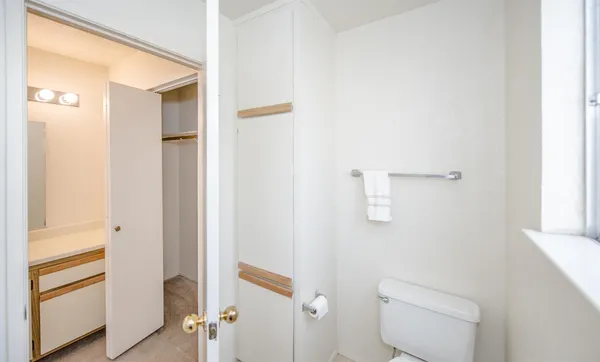 a bathroom with a toilet and a shower