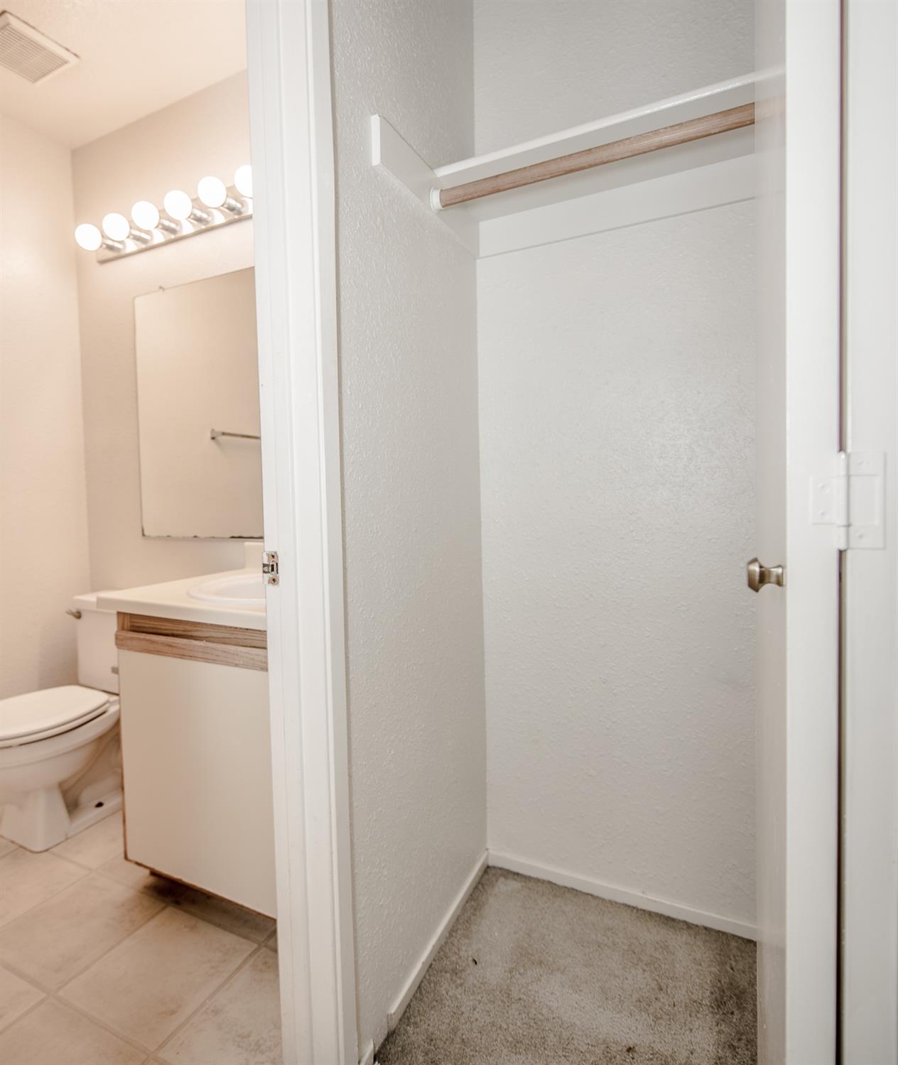 1019 Dornajo Way, Unit 244 Sacramento, CA 95825 - Photo 26 of 41 a bathroom with a granite countertop sink a toilet and a mirror