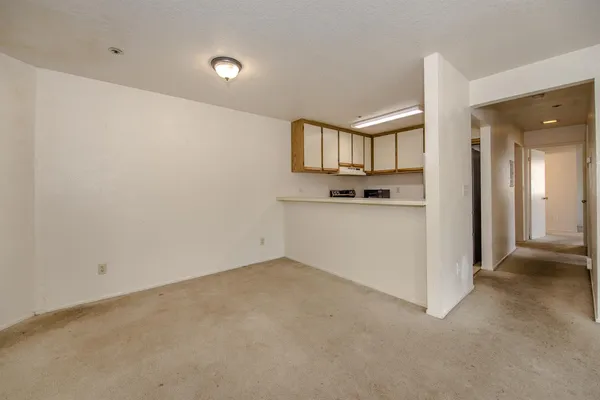 an empty room with kitchen and sink