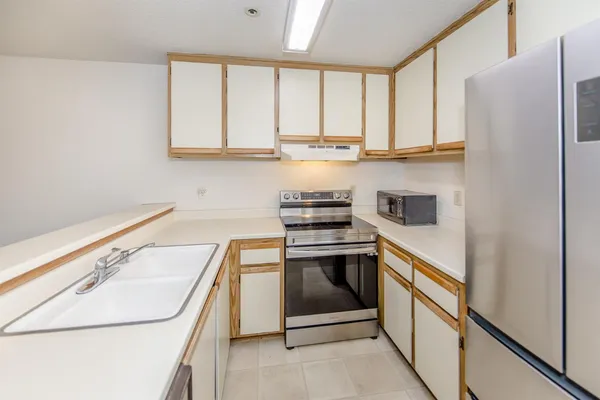 a kitchen with stainless steel appliances granite countertop a sink and a stove
