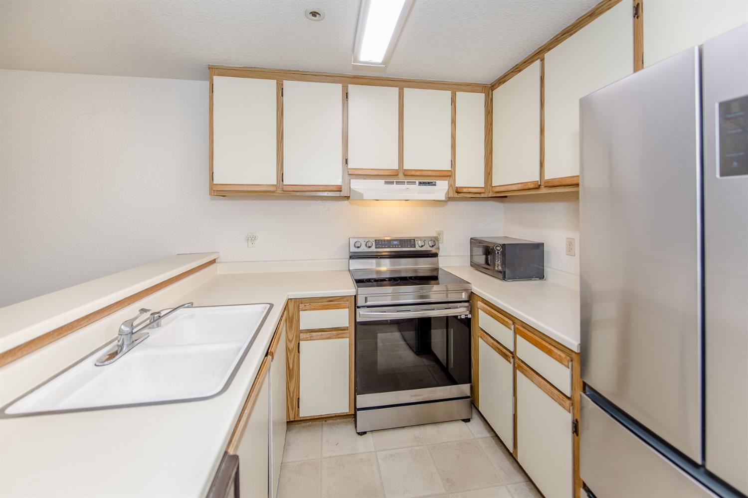1019 Dornajo Way, Unit 244 Sacramento, CA 95825 - Photo 10 of 41 a kitchen with stainless steel appliances granite countertop a sink and a stove