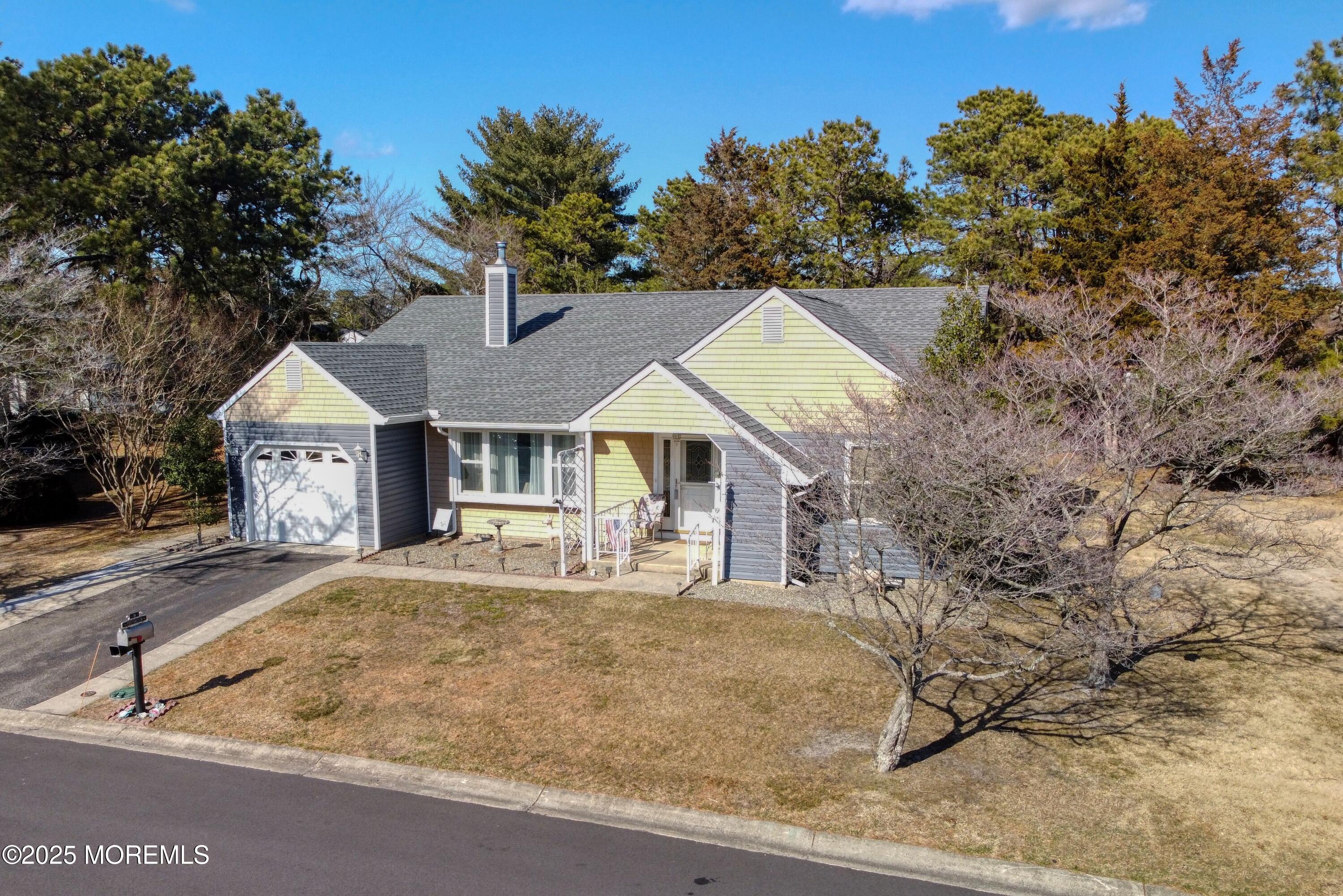 19 Amesbury Road Whiting, NJ 08759 - Photo 26 of 26 a front view of a house with table and chairs