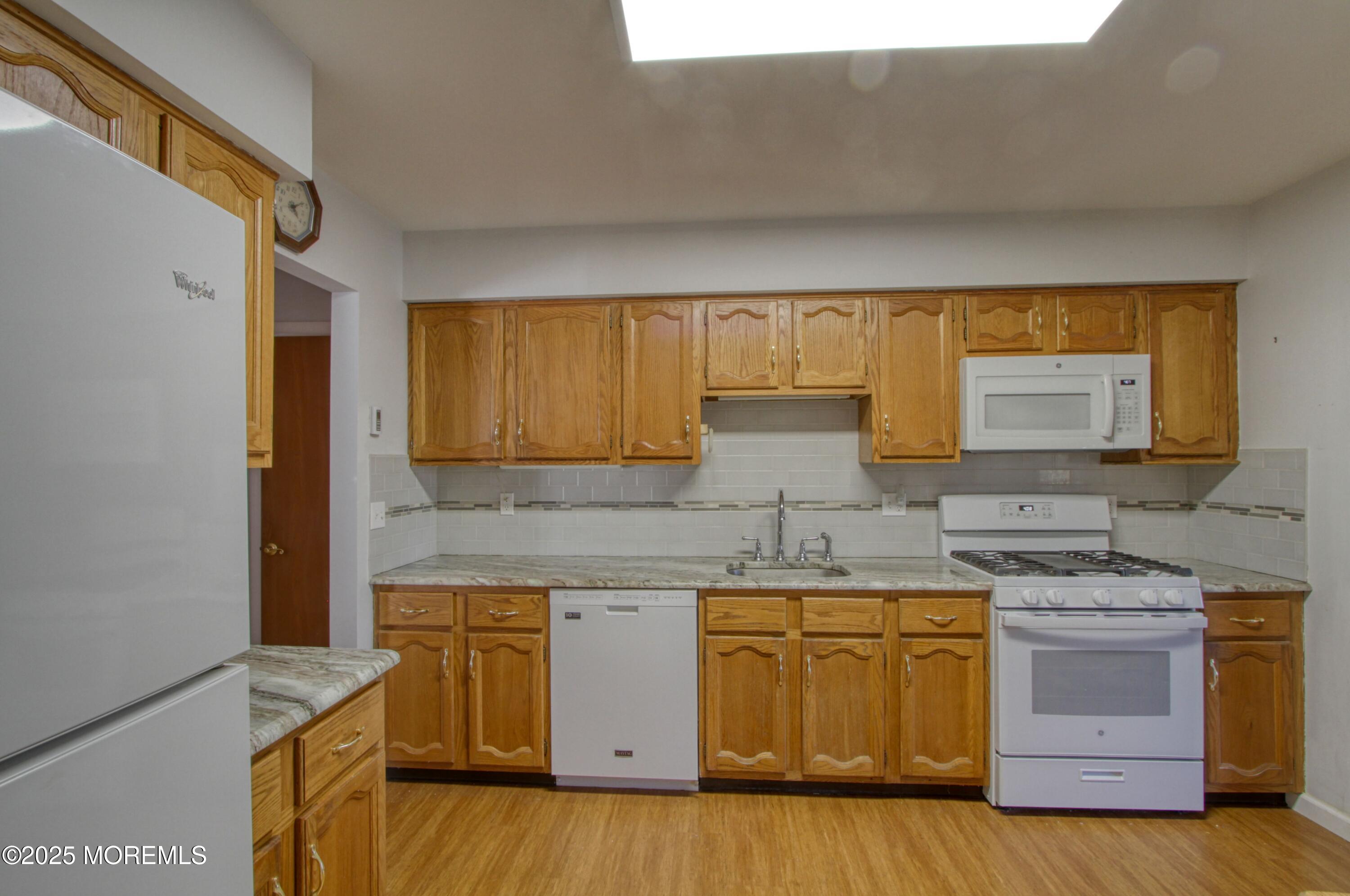 19 Amesbury Road Whiting, NJ 08759 - Photo 3 of 26 a kitchen with a sink stove and cabinets
