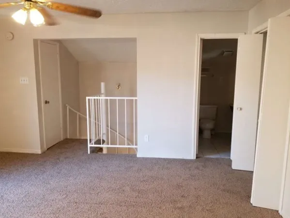 a view of an empty room with closet