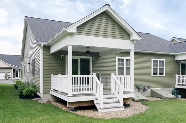 a view of a house with a yard and deck