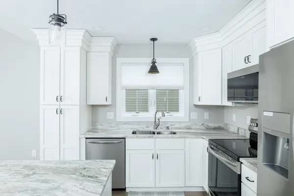 a kitchen with a sink stove and microwave