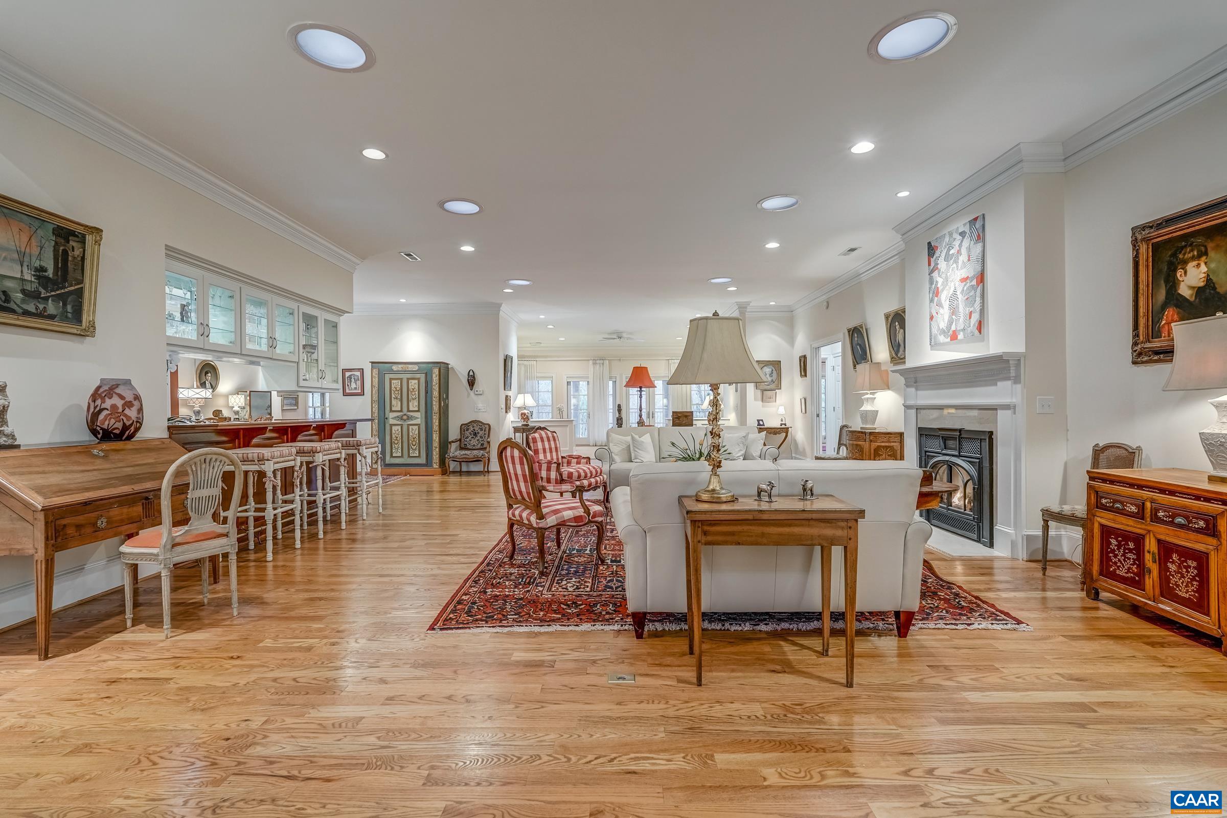 1849 Westerham Street Keswick, VA 22947 - Photo 24 of 75 a living room with furniture a dining table and a fireplace