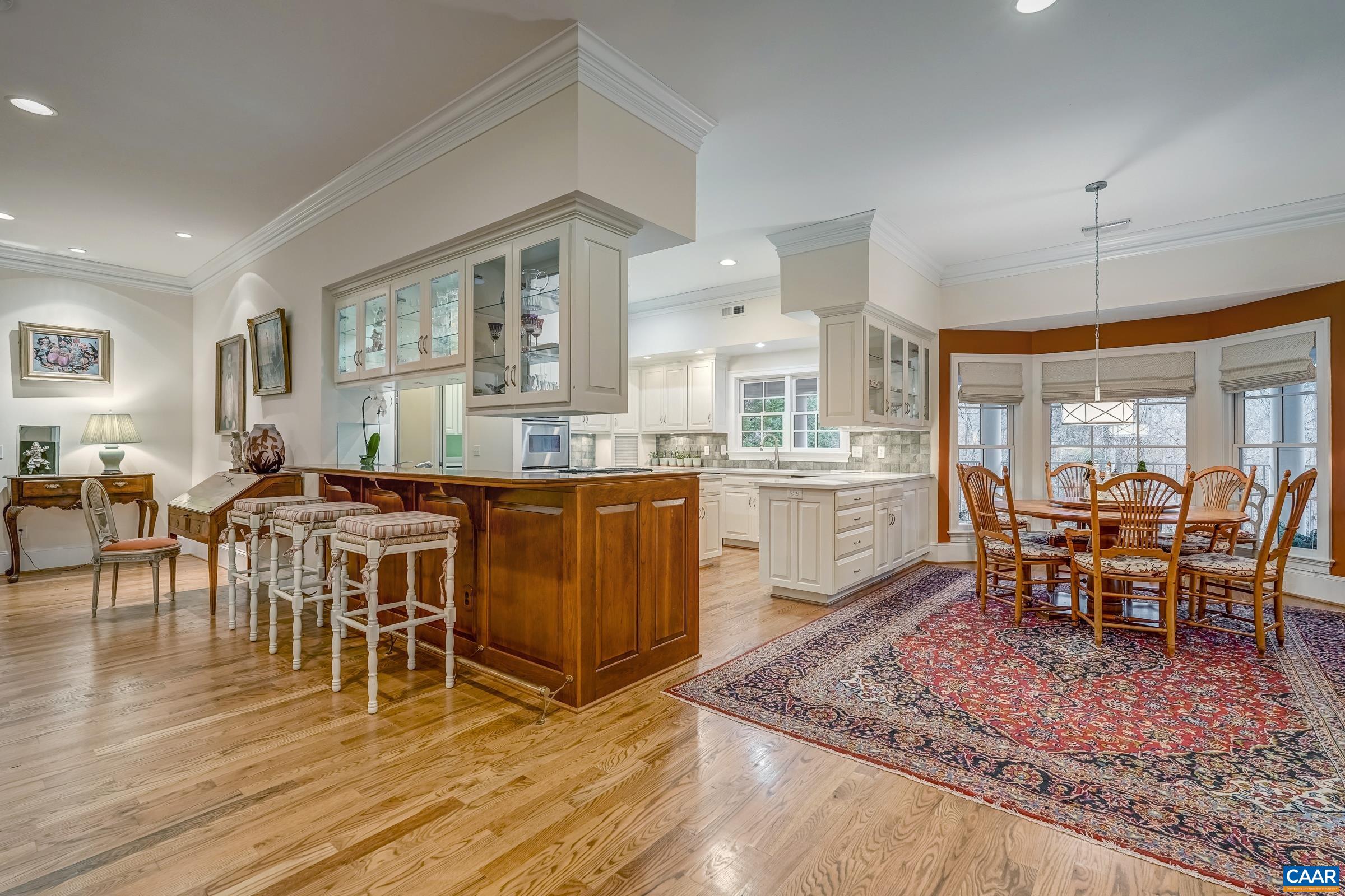 1849 Westerham Street Keswick, VA 22947 - Photo 37 of 75 a large dining hall with stainless steel appliances granite countertop a stove a sink a dining table and chairs with wooden floor