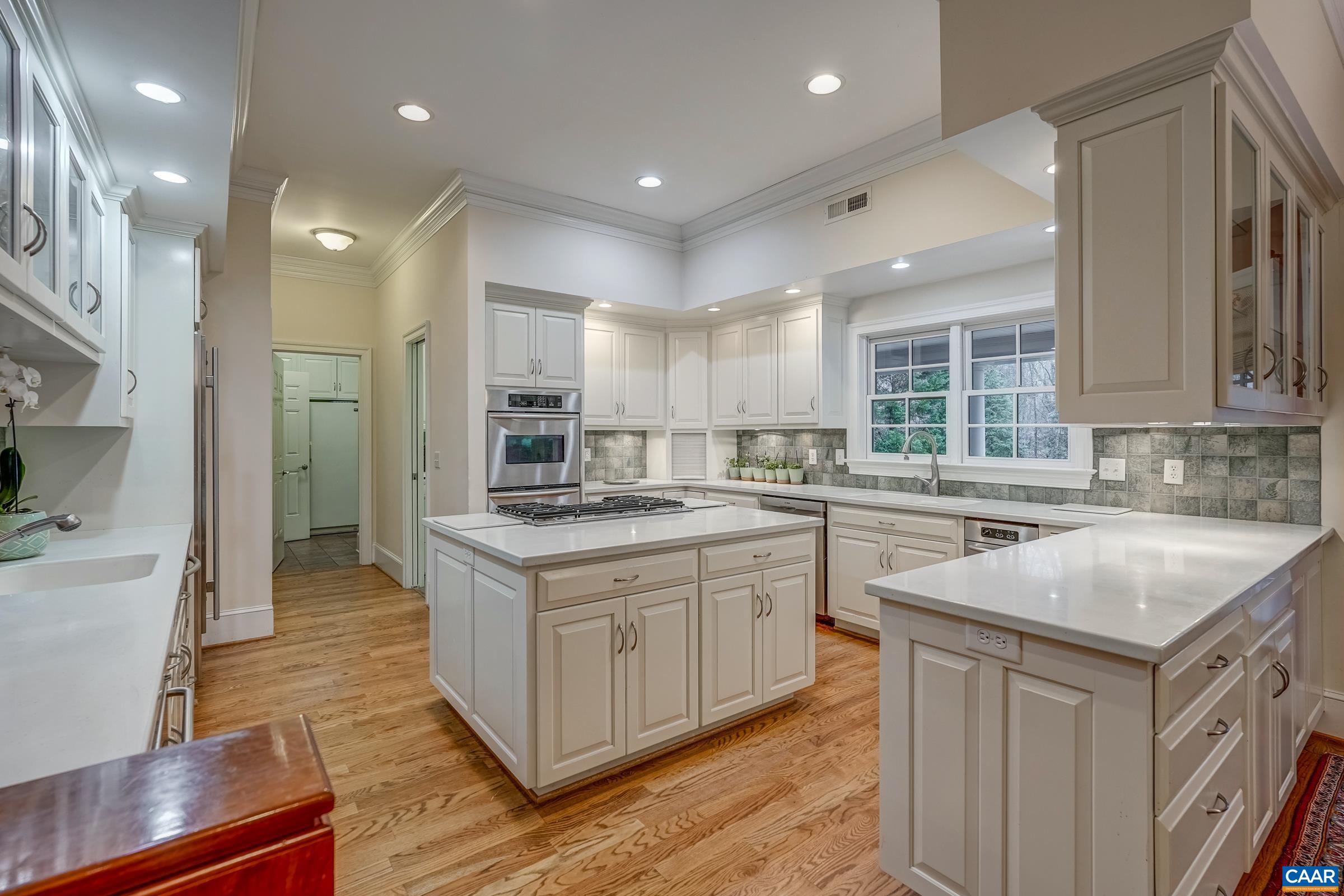 1849 Westerham Street Keswick, VA 22947 - Photo 39 of 75 a kitchen with stainless steel appliances granite countertop a sink stove and refrigerator