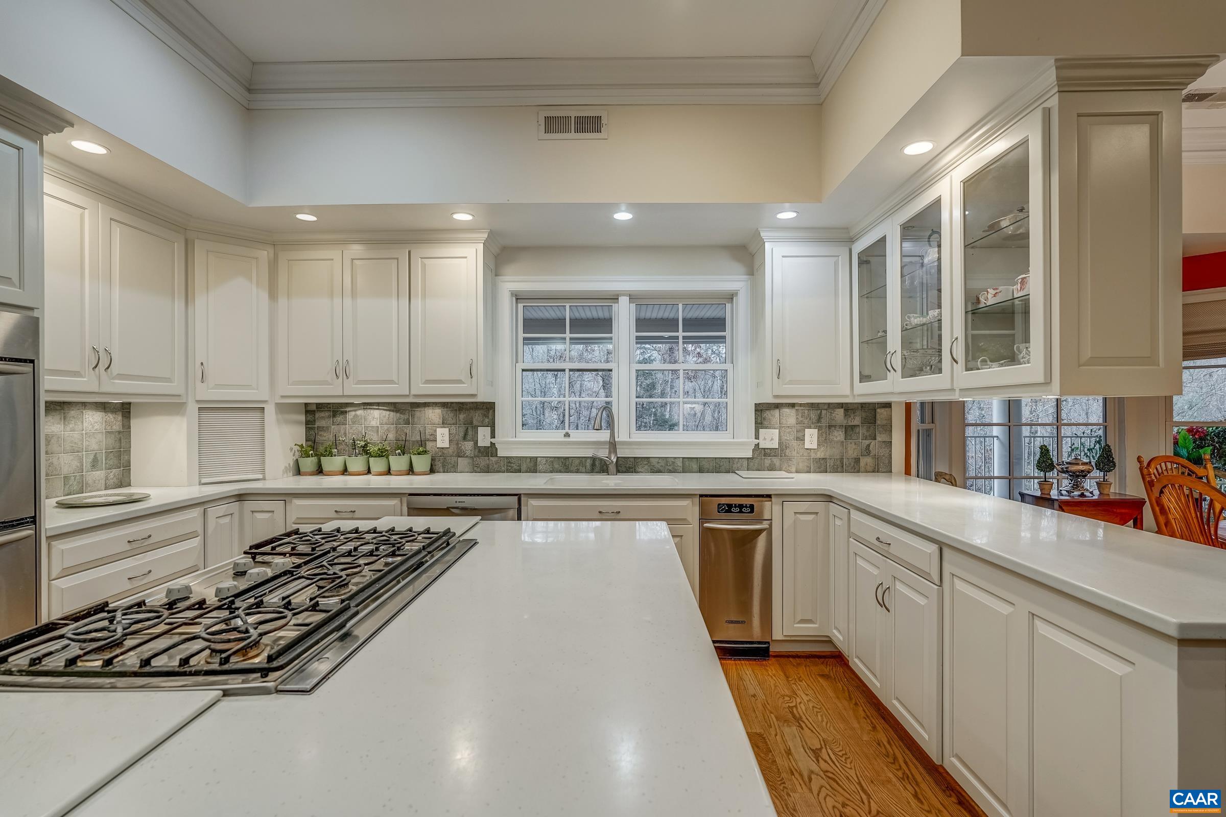 1849 Westerham Street Keswick, VA 22947 - Photo 43 of 75 a large kitchen with stainless steel appliances granite countertop a stove a sink dishwasher and white cabinets with wooden floor