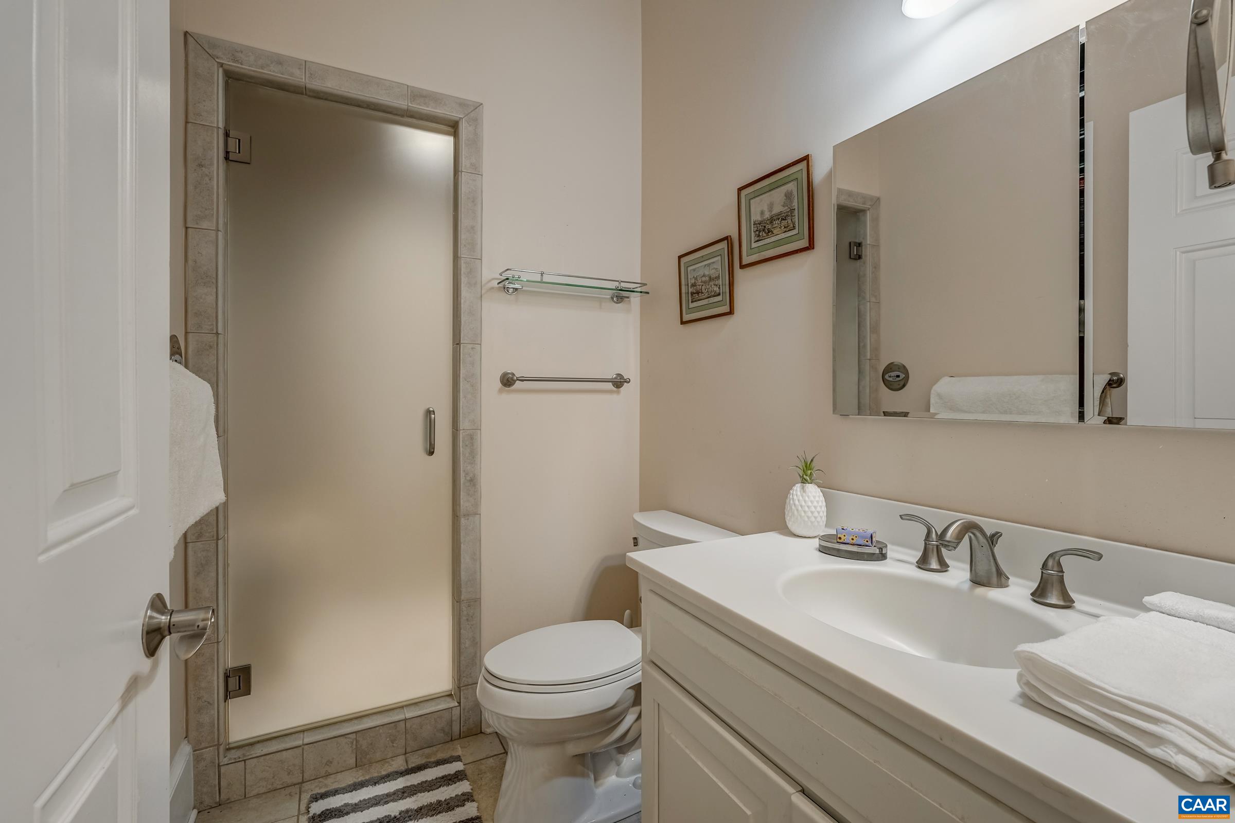 1849 Westerham Street Keswick, VA 22947 - Photo 54 of 75 a bathroom with a granite countertop sink mirror vanity and toilet
