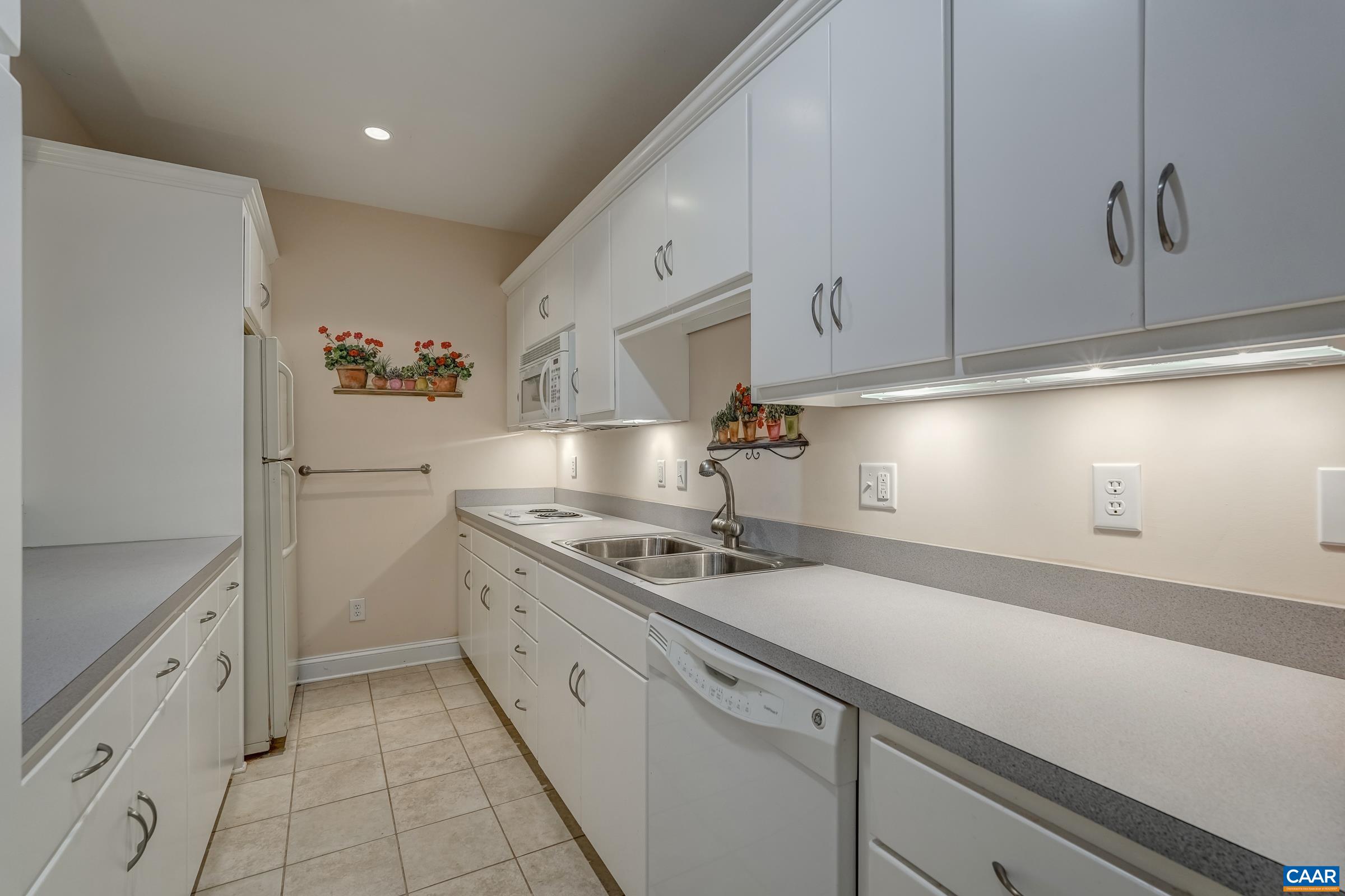 1849 Westerham Street Keswick, VA 22947 - Photo 61 of 75 a kitchen with white cabinets and white appliances