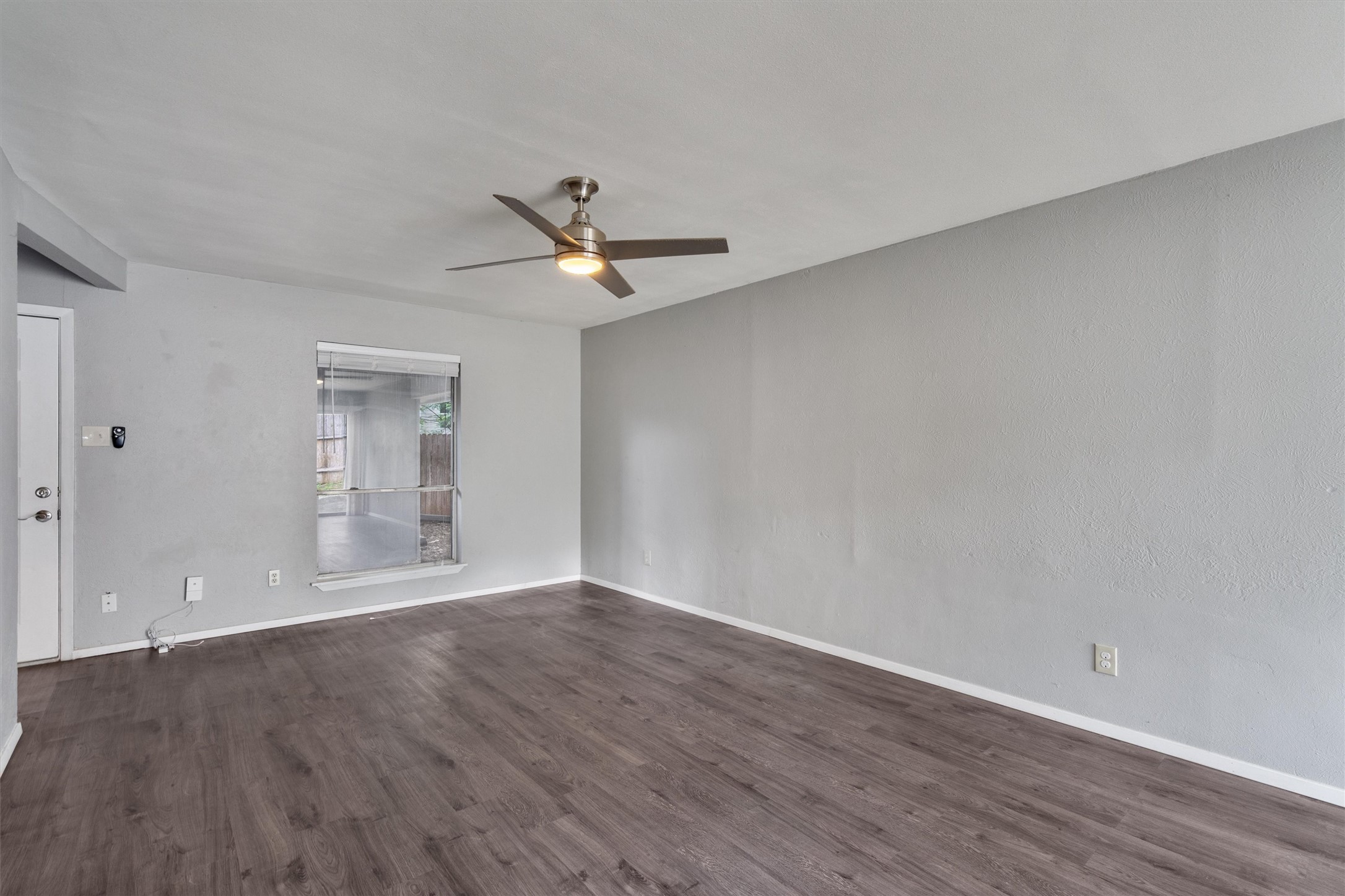 3415 Menchaca Road, Unit 113 Austin, TX 78704 - Photo 3 of 21 an empty room with wooden floor and windows