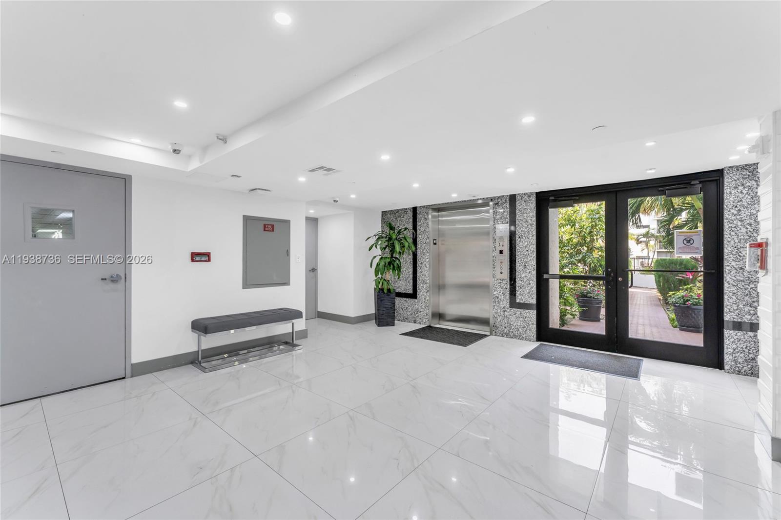 16919 North Bay Road, Unit 118 Sunny Isles Beach, FL 33160 - Photo 12 of 20 a view of a lobby with a floor to ceiling window and floor to ceiling window