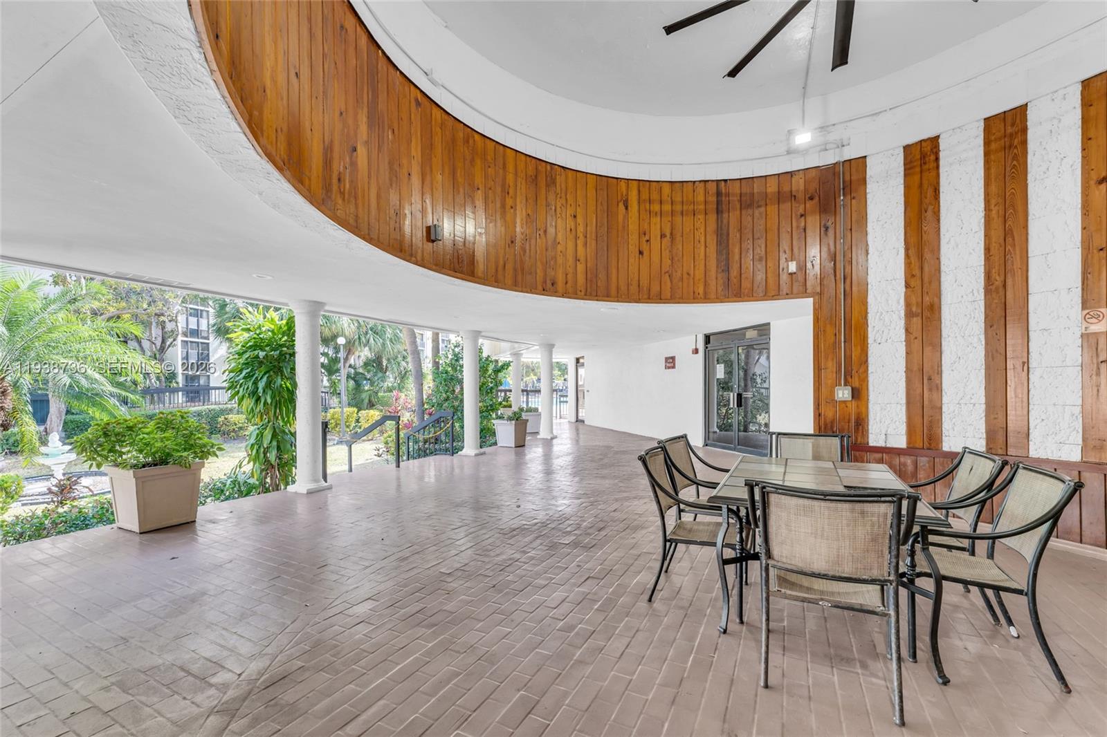 16919 North Bay Road, Unit 118 Sunny Isles Beach, FL 33160 - Photo 13 of 20 a dining room with furniture window and garden view