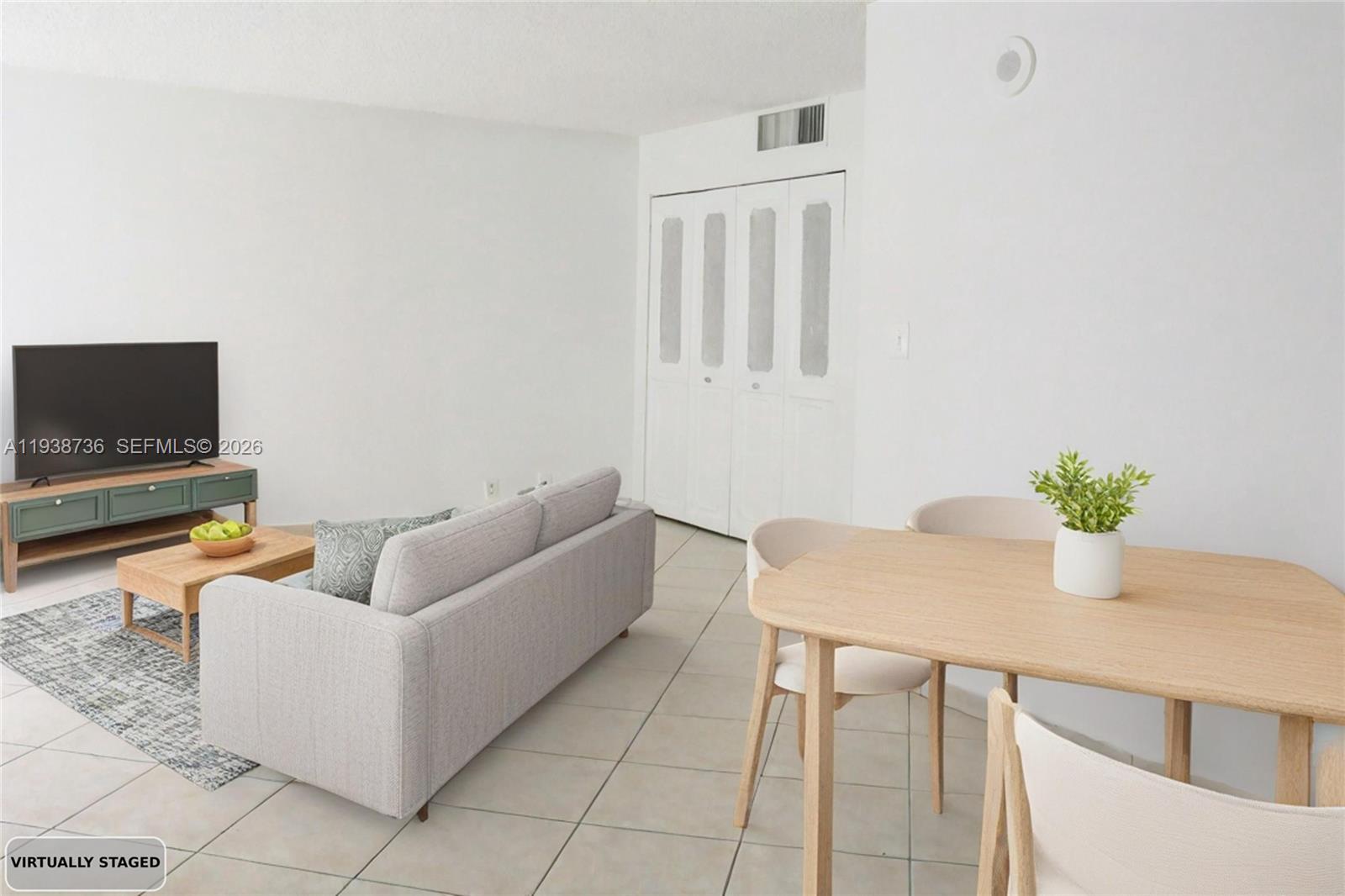 16919 North Bay Road, Unit 118 Sunny Isles Beach, FL 33160 - Photo 2 of 20 a living room with furniture and a flat screen tv