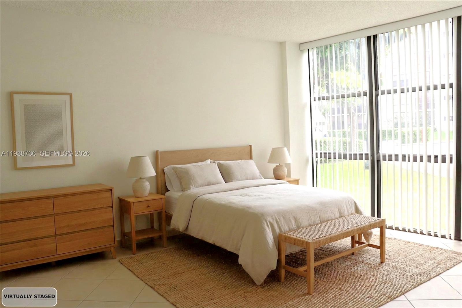 16919 North Bay Road, Unit 118 Sunny Isles Beach, FL 33160 - Photo 5 of 20 a bedroom with a bed chair and window