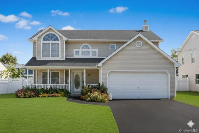 a front view of a house with a garden and plants