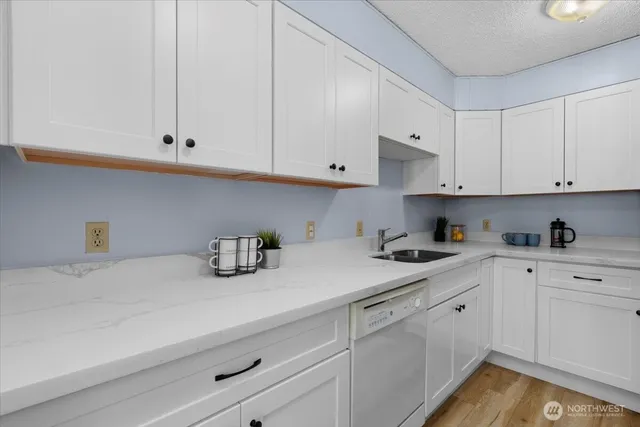 a kitchen with cabinets appliances and a sink