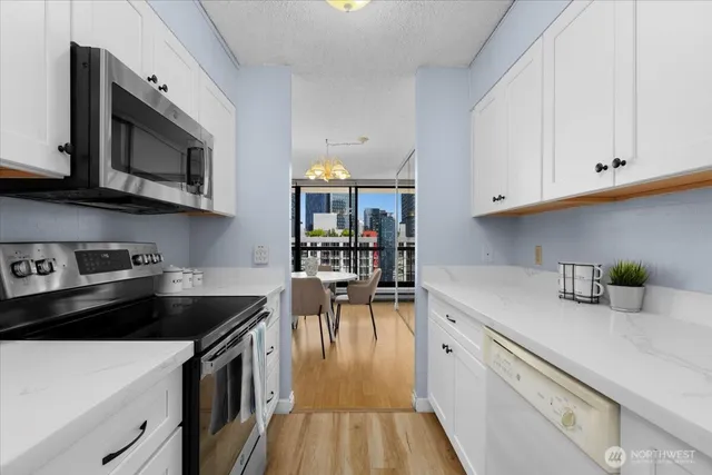 a kitchen with a sink a stove and cabinets
