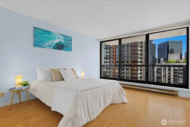 a spacious bedroom with a large bed and a large window