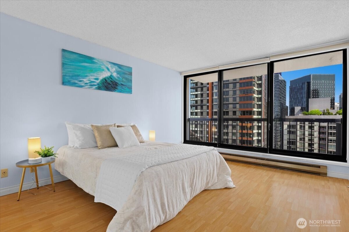 2100 3rd Avenue, Unit 2505 Seattle, WA 98121 - Photo 15 of 40 a spacious bedroom with a large bed and a large window