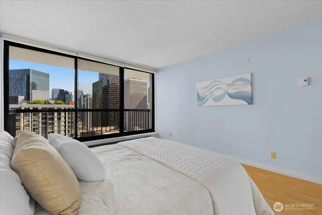 a bedroom with a large bed and a large window