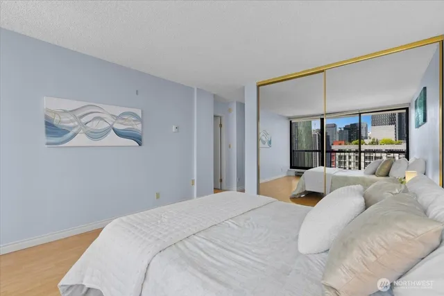 a bedroom with a large bed and a window