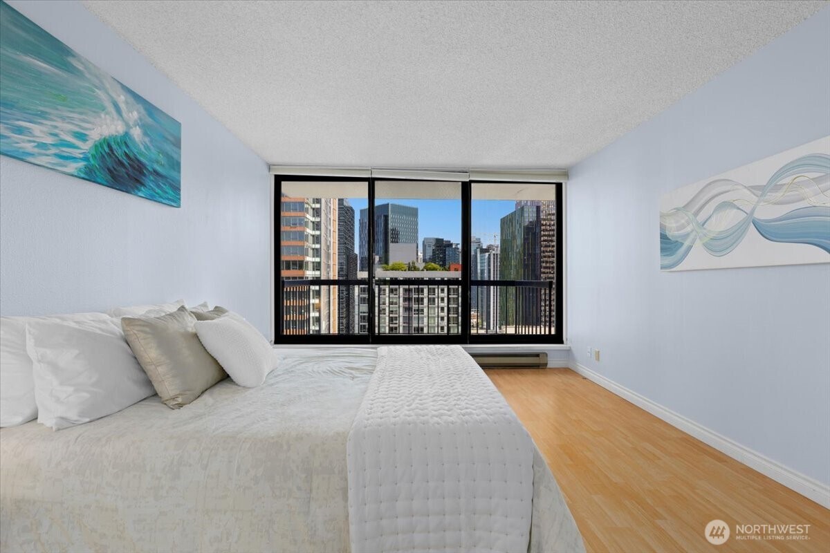 2100 3rd Avenue, Unit 2505 Seattle, WA 98121 - Photo 18 of 40 a view of a bedroom with furniture and floor to ceiling window