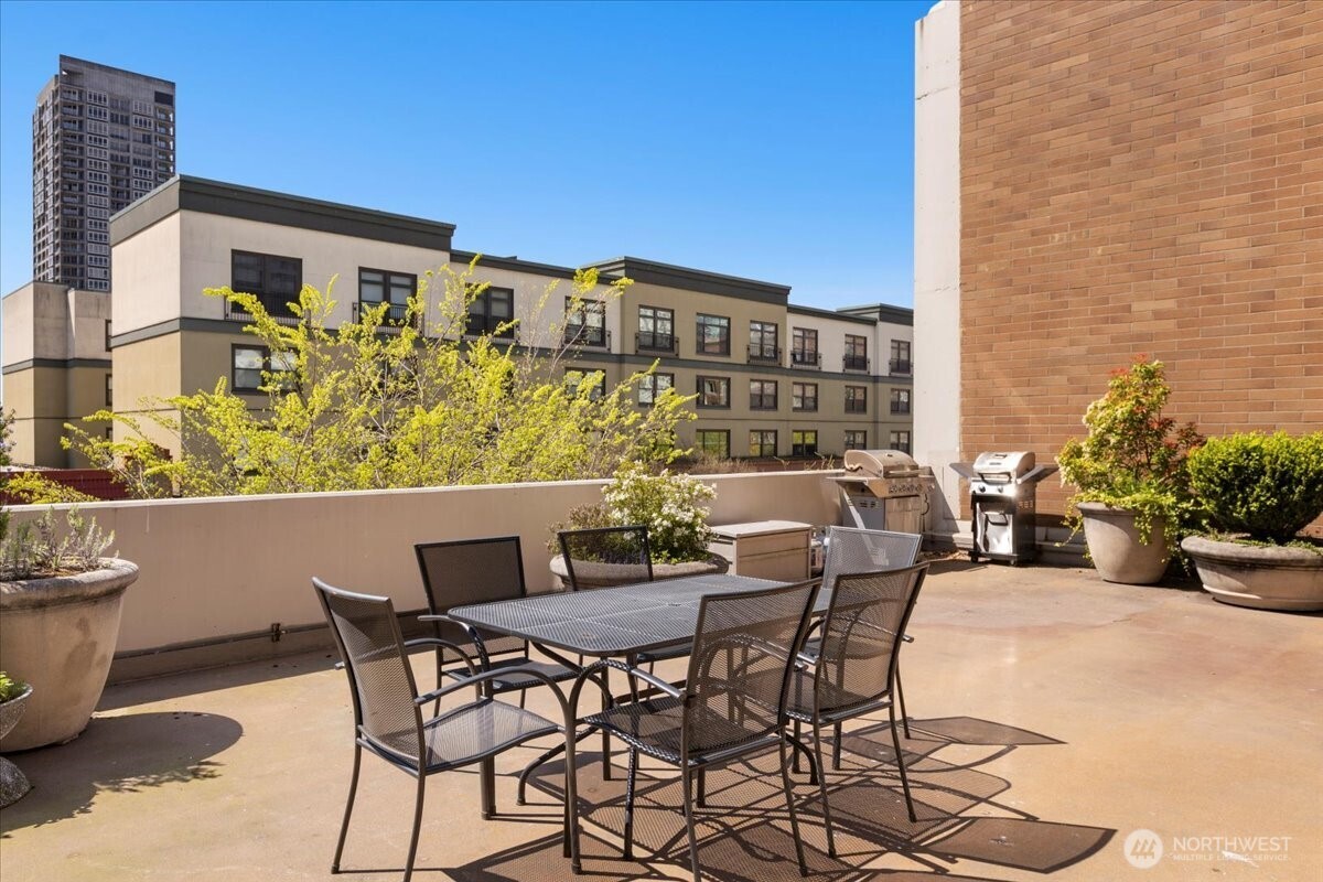 2100 3rd Avenue, Unit 2505 Seattle, WA 98121 - Photo 30 of 40 a view of a patio with table and chairs and potted plants