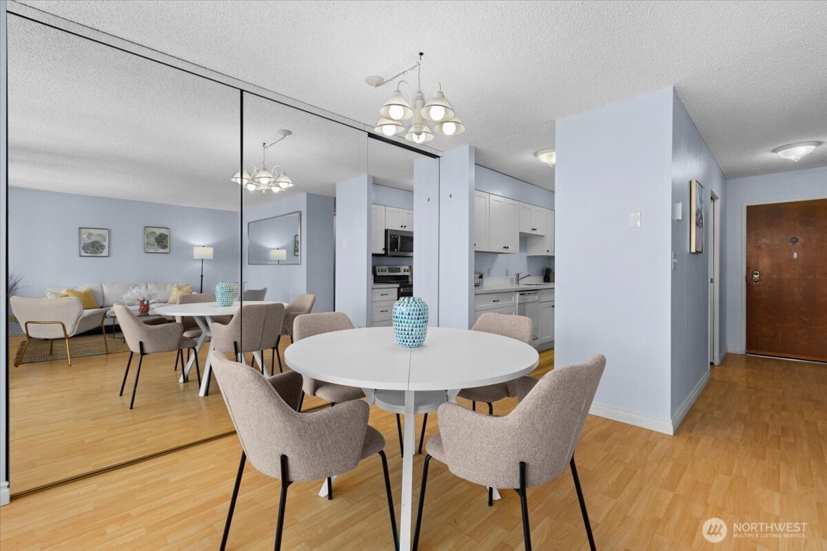 2100 3rd Avenue, Unit 2505 Seattle, WA 98121 - Photo 8 of 40 a view of a dining room with furniture and chandelier