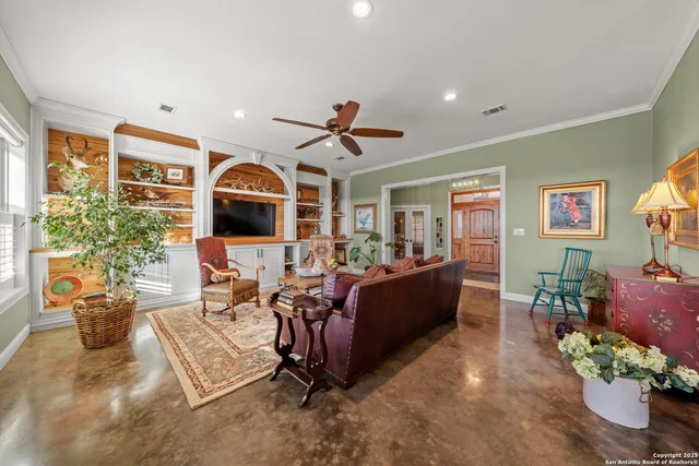a living room with furniture flat screen tv and a large window
