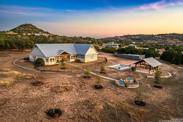 an aerial view of a house with outdoor space